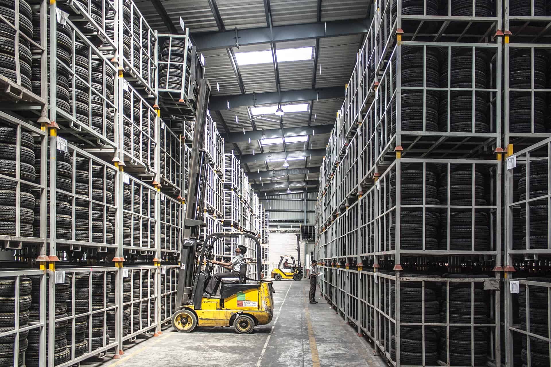 Warehouse full of tyres with forklifts