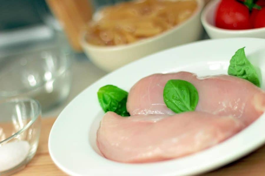 ‘Touch-Free’ Pouches: Two pieces of raw chicken in a white bowl