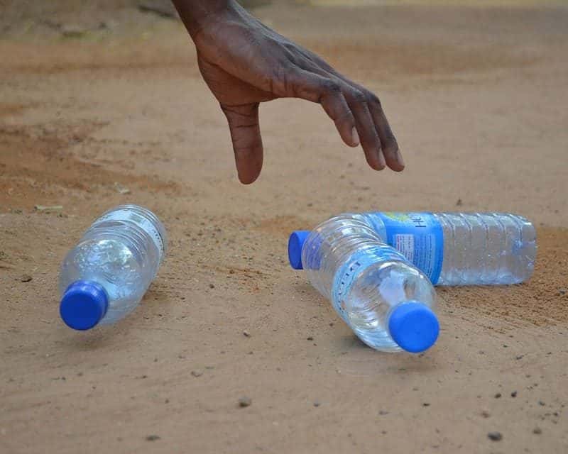 Polyethylene bottles being picked up from a beach