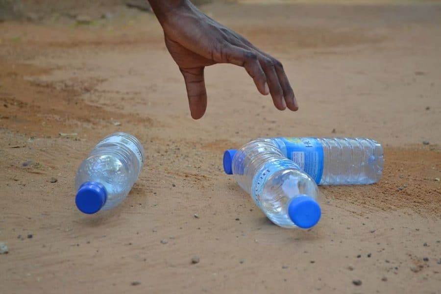 Polyethylene bottles being picked up from a beach